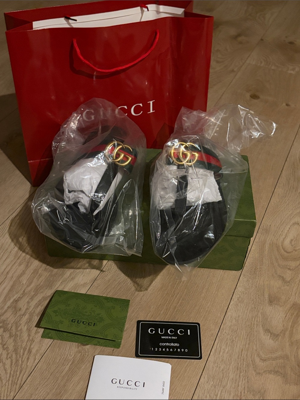 Gucci women’s Black Leather Thong Sandals with Signature Web Stripe